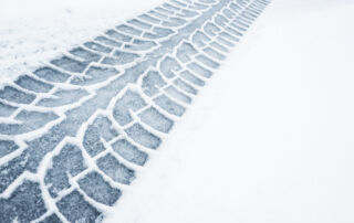 Car track on a wet snowy road, closeup background photo